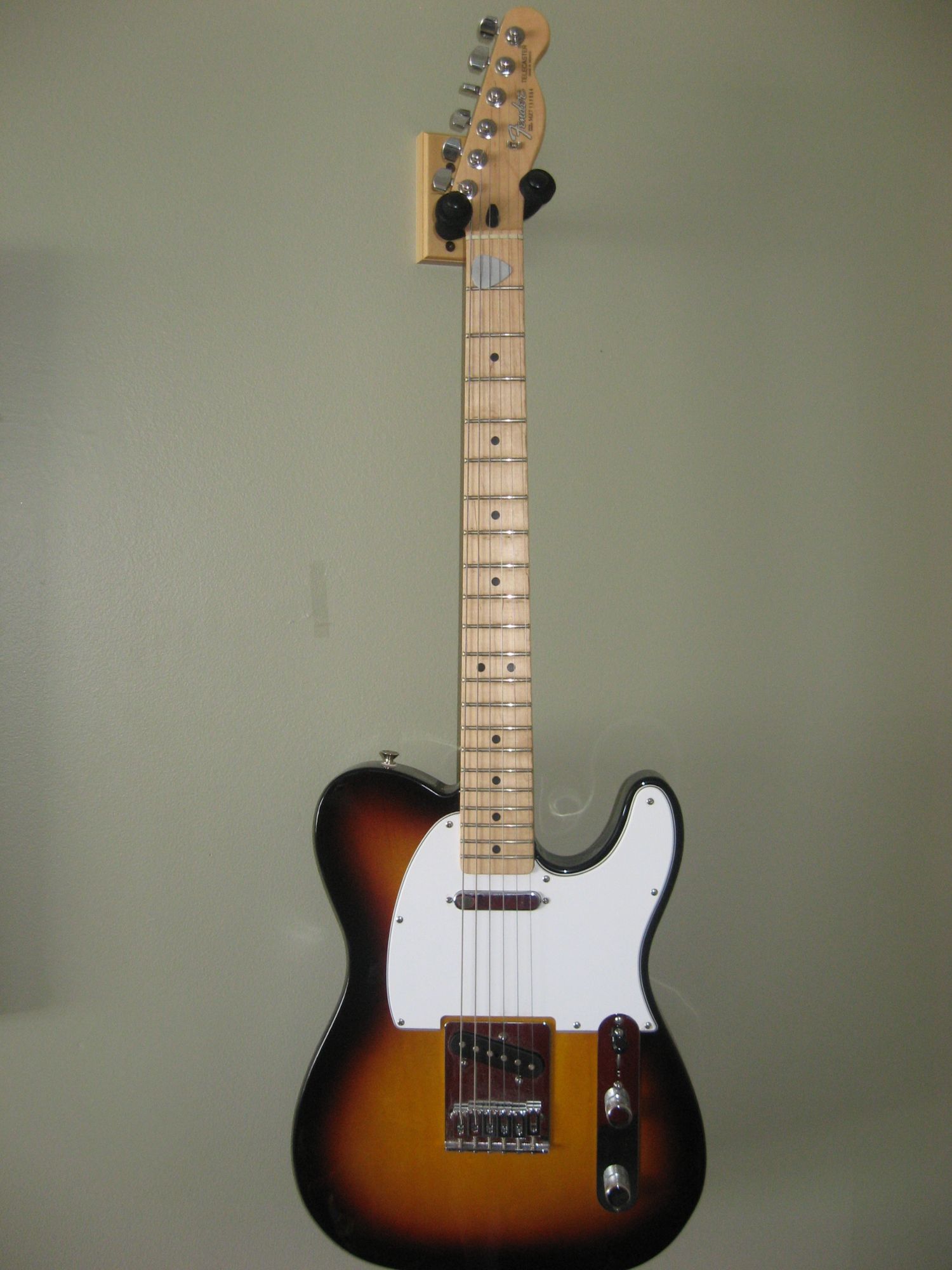 Fender Telecaster in three-tone sunburst with a maple neck and white pickguard