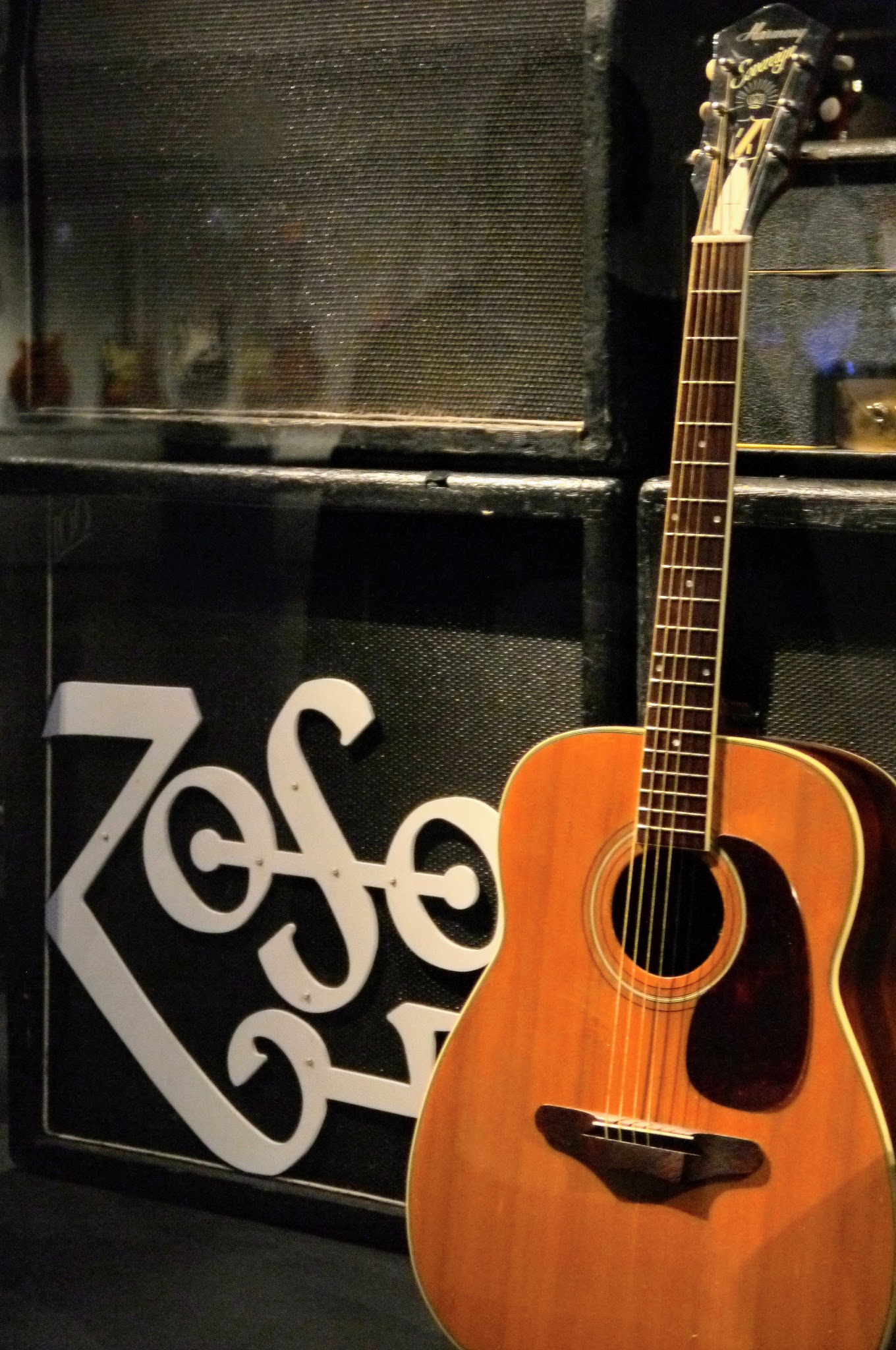 Jimmy Page's Harmony Sovereign H1260 flat-top acoustic on display in front of an amplifier stack